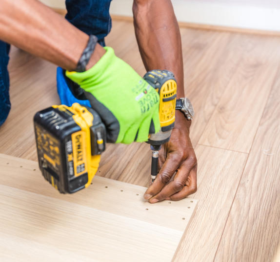 This is a picture of a handyman fixing a floor.