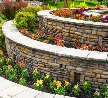 This is a picture of a flower bed with a small retaining wall.